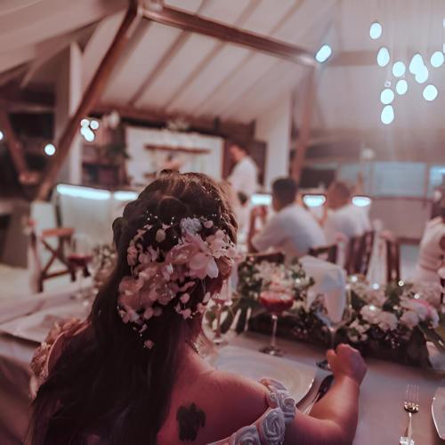 a girl sitting at a table with a flower crown on her head at Mikado Natural Lodge in Playa Avellana