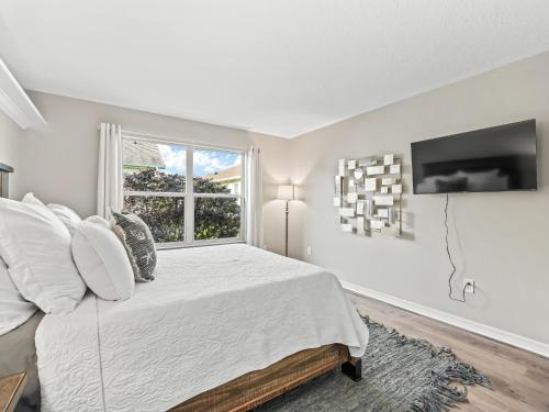 a white bedroom with a bed and a window at 3270 Z2A VILLAGE OF GLENBROOK by REMAX Premier in The Villages