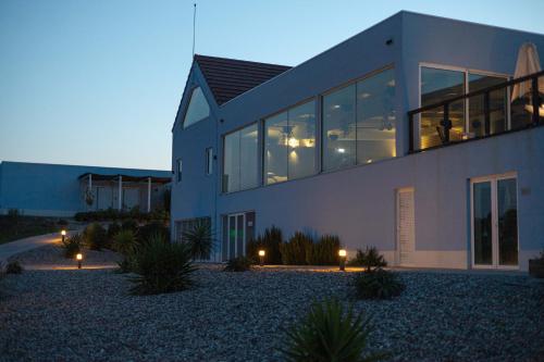 a large building with lights in front of it at Sleep & Nature Hotel in Lavre