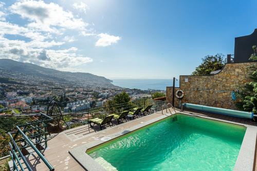 a swimming pool on top of a building at Casa Barcelos View in Funchal
