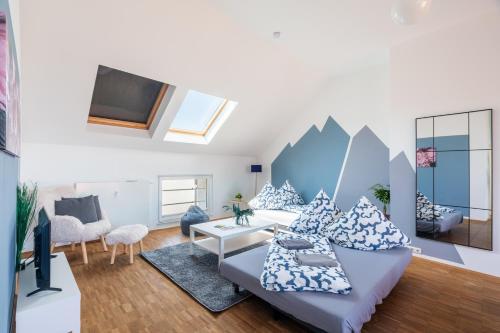 a living room with a couch and a tv at Sky Loft Leipzig - moderne Dachwohnung mit Terrasse und Blick aufs Rathaus in Leipzig