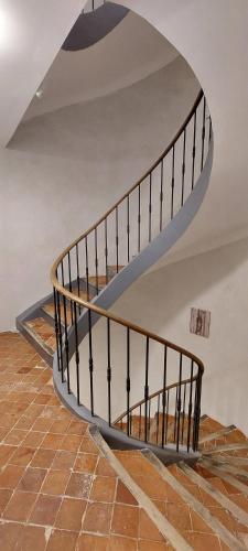 a spiral staircase in a building with a tile floor at Le Lavandin classé 3 étoiles in Riez