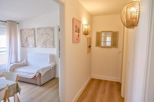a living room with a chair and a table at Apartamento Sear Areas in Sanxenxo