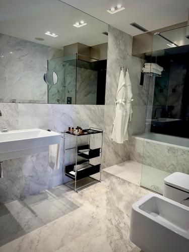 a bathroom with a sink and a toilet and a shower at Hotel Inffinit in Vigo
