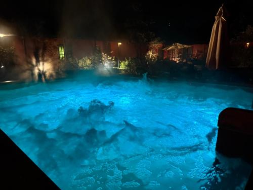 a pool filled with blue water at night at Casona Lo Aguirre , Hospedaje de Temporada Cálidas in Talagante