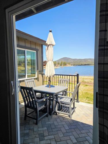 a patio with a table and chairs and an umbrella at Big Bear Frontier in Big Bear Lake