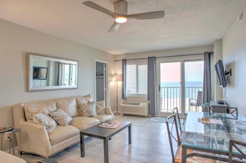 a living room with a couch and a table at Inviting Virginia Beach Condo with Community Pool in Virginia Beach