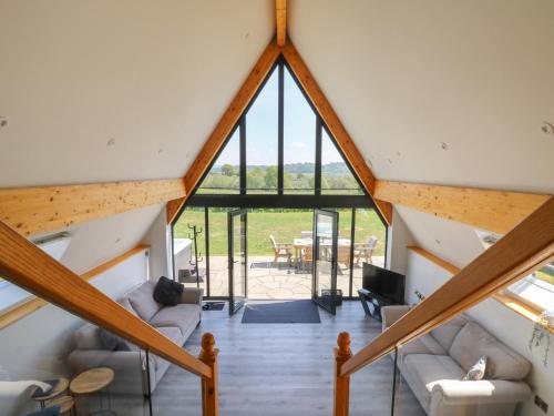 a view from the loft of a house with a large window at Hill Radnor - The Sheepfold in Llandrindod Wells
