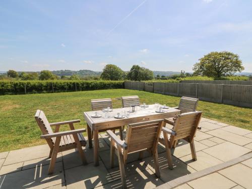 a wooden table and chairs on a patio at Hill Radnor - The Sheepfold in Llandrindod Wells