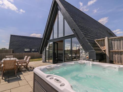 a large jacuzzi tub on a patio at Hill Radnor - The Sheepfold in Llandrindod Wells