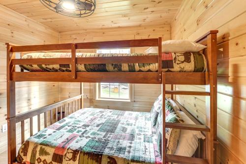 a bedroom with two bunk beds in a cabin at Waterfront Davis Pond Cabin with Dock and Kayaks! in Holden