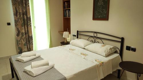 a bedroom with a bed with white sheets and pillows at Juliette Apartments in Faraklata