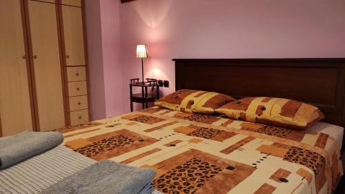 a bed with two pillows on it in a bedroom at Juliette Apartments in Faraklata