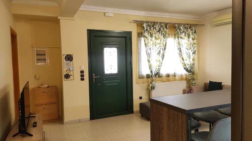 a green door in a room with a table at Juliette Apartments in Faraklata