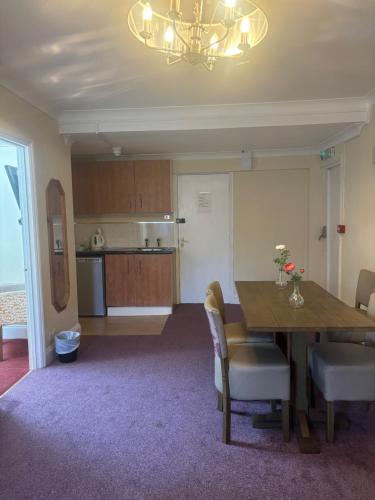 a kitchen and dining room with a table and chairs at Rothwell House Hotel in Kettering