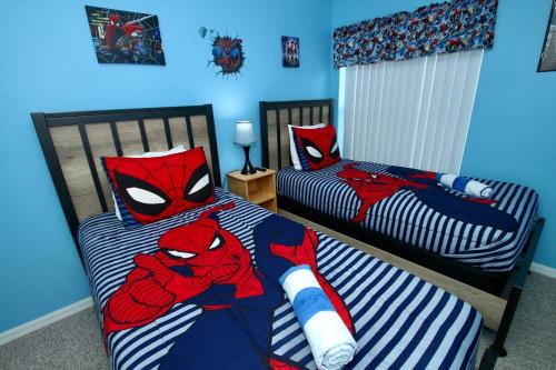 a bedroom with two beds with spider man sheets at Family Escape Close to parks in Orlando