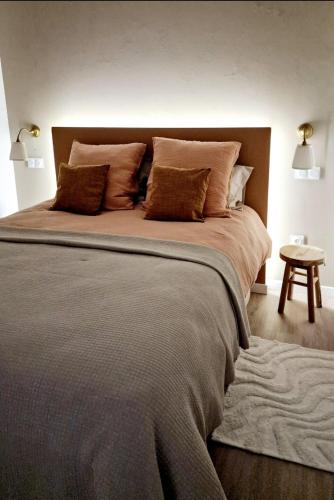 a bedroom with a large bed with pillows at O Encanto no Centro de Coimbra in Coimbra