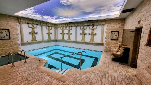 a large indoor swimming pool with a ceiling at Panorama Family Hotel in Zlatograd