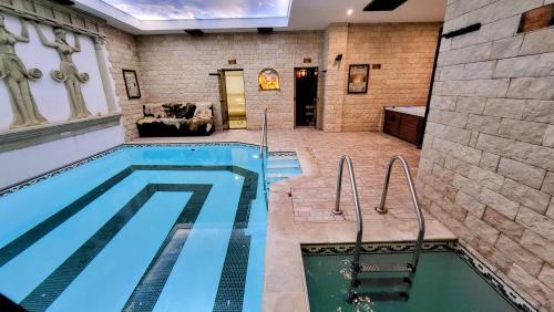 a swimming pool in a house with a large room at Panorama Family Hotel in Zlatograd