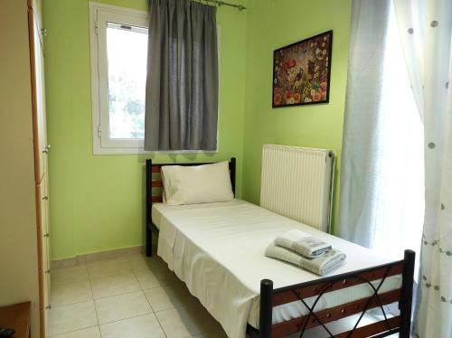 a small bedroom with a bed and a window at Juliette Apartments in Faraklata