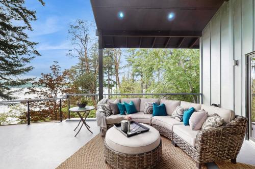 a living room with a couch on a patio at Puget Sound Orca Retreat in Poulsbo