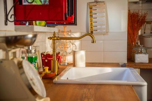 a kitchen counter with a sink and a faucet at Vitta's House in Kanali