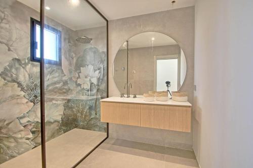 une salle de bain avec un lavabo et un miroir dans l'établissement Villa vue mer, piscine, plage à pieds, à Hyères