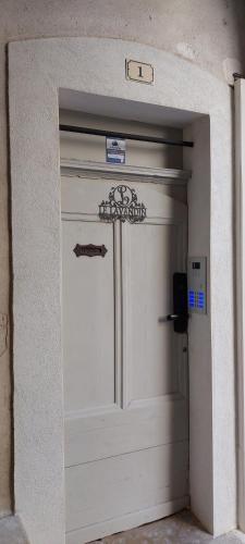 a white garage door with a sign on it at Le charme sous les toits classé 3 étoiles in Riez