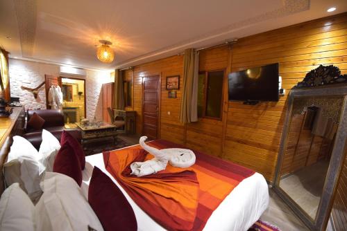 a room with a bed with a stuffed animal on it at RIAD KALE POLIS in Marrakech