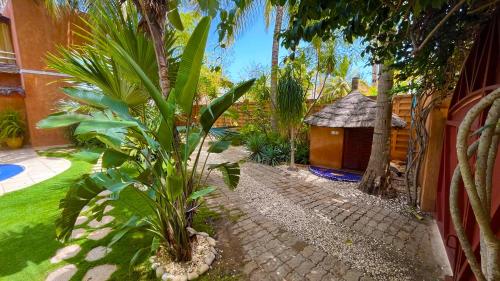 a garden with a small house and a plant at Villa Zehliana in Saly Portudal