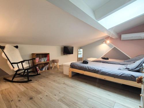 a bedroom with a bed and a chair in it at Villa Élégante à Berre-les-Alpes - Terrasse, Piscine & Vue Panoramique in Berre-les Alpes