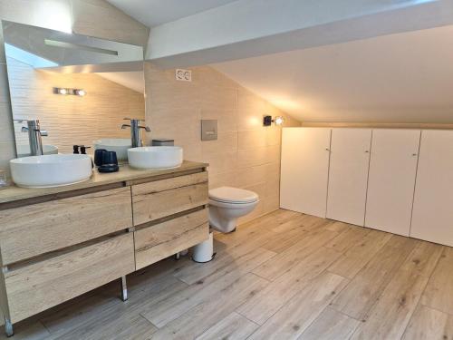 a bathroom with two sinks and a toilet at Villa Élégante à Berre-les-Alpes - Terrasse, Piscine & Vue Panoramique in Berre-les Alpes
