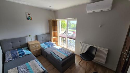 a small room with two beds and a window at Noclegi Mazur przysiersk in Przysiersk