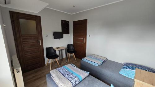 a living room with a couch and a table at Noclegi Mazur przysiersk in Przysiersk