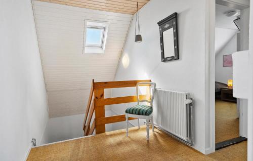 a small staircase with a chair in a room at 3 Bedroom Awesome Home In Kalvehave in Kalvehave