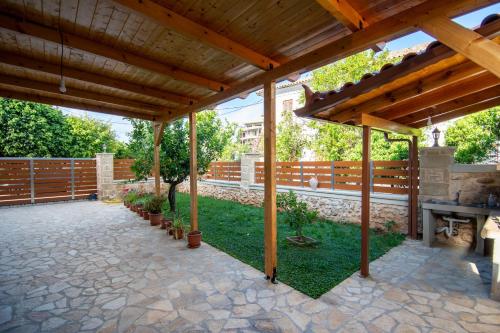 an outdoor patio with a wooden pergola at Dionysis Elegant Cozy Apartment in Filiatra