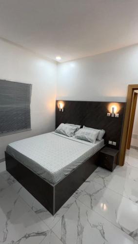 a bedroom with a large bed in a room at Keylah Guest House in Cotonou