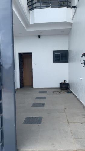 an empty hallway with a door in a building at Keylah Guest House in Cotonou