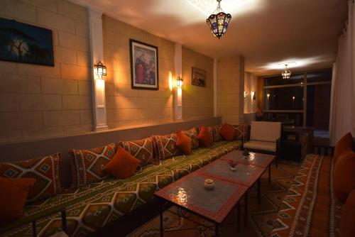 a living room with a couch and a table at RIAD KALE POLIS in Marrakech