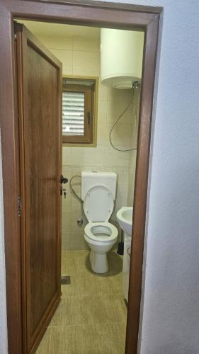 a small bathroom with a toilet and a sink at Panorama in Plav