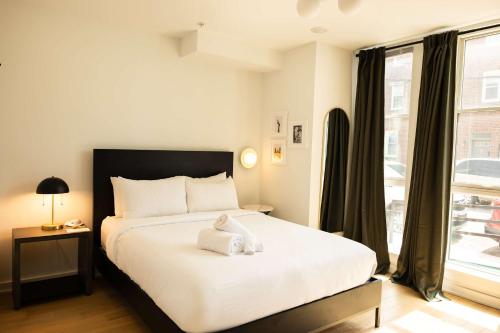 Un dormitorio con una cama con una toalla encima. en Sosuite at The Jefferson - Fishtown, en Filadelfia