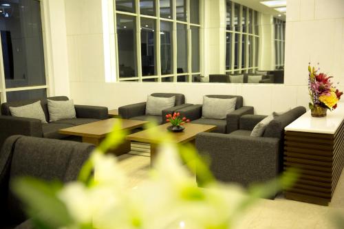 a waiting area with couches and tables in a building at Maha Bodhi Hotel.Resort.Convention Centre in Bodh Gaya