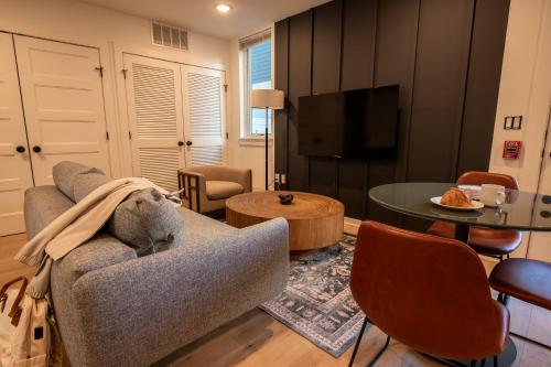 a living room with a couch and a table at Sosuite at The Jefferson - Fishtown in Philadelphia