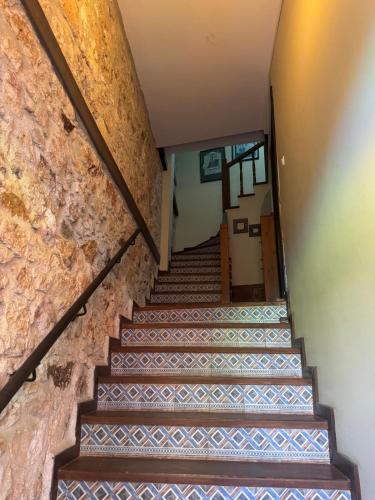 a staircase in a building with a stone wall at The Old Stone House in Ayvalık