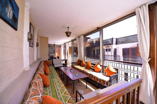 a balcony with couches and a table on a balcony at RIAD KALE POLIS in Marrakech