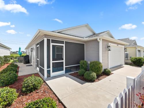 una casa con una valla blanca en 6283 Z5 VILLAGE OF CITRUS GROVE by REMAX Premier, en The Villages