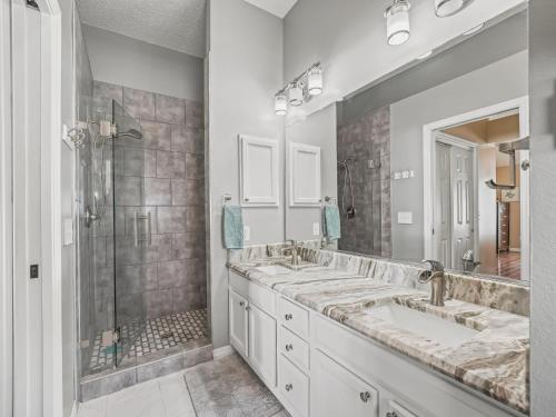 a bathroom with two sinks and a shower at 704 Z2B VILLAGE OF RIO GRANDE by REMAX Premier in The Villages
