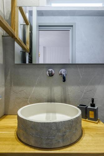 a bathroom with a large circular sink in a room at Skopelos Prime Central Stays in Skopelos Town