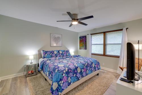 a bedroom with a bed and a ceiling fan at Holiday Island Home Mountain View and Hot Tub! in Holiday Island