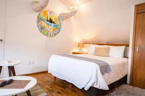 a bedroom with a bed and a table at The Gallery in Mexico City